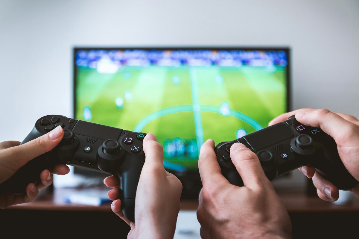 Two players with controllers playing a football game