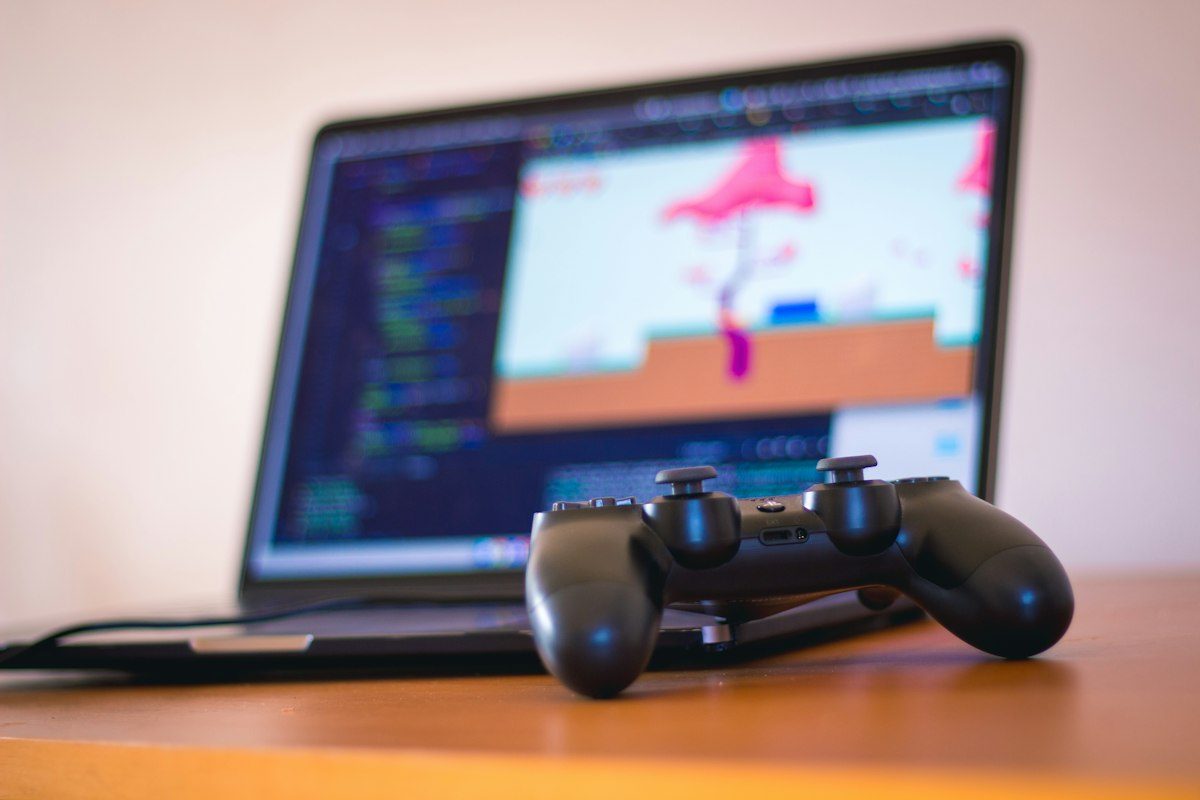 Indie platformer running on a laptop next to a controller